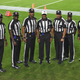 NFL officials, from left, umpire Barry Anderson, field judge Anthony Jeffries, down judge Julian Mapp, referee Jerome Boger, back judge Greg Steed, side judge Dale Shaw (104), line judge Carl Johnson (101) pose for a photo before an NFL football game between the Tampa Bay Buccaneers and the Los Angeles Rams Monday, Nov. 23, 2020, in Tampa, Fla.